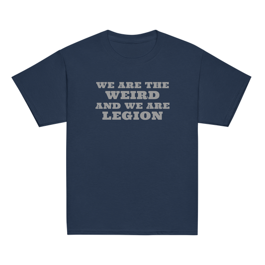 "We are the weird and we are legion" printed on a navy youth classic tee laying on a flat surface