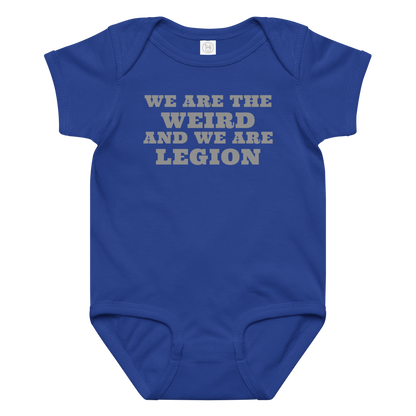 "We are the weird and we are legion" printed on a royal baby jersey bodysuit laying on a flat surface amongst other clothes