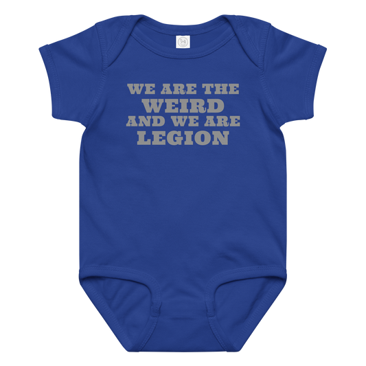 "We are the weird and we are legion" printed on a royal baby jersey bodysuit laying on a flat surface amongst other clothes