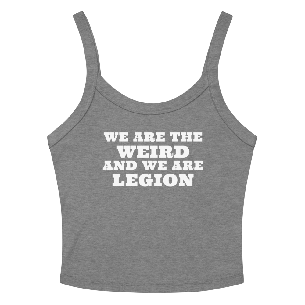"We are the weird and we are legion" printed on a athletic heather women's micro-rib tanktop laying on a flat surface amongst sunglasses and shorts