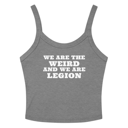 "We are the weird and we are legion" printed on a athletic heather women's micro-rib tanktop laying on a flat surface amongst sunglasses and shorts