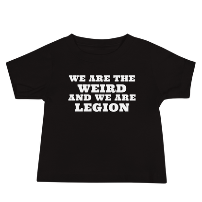 "We are the weird and we are legion" printed on a black baby jersey short sleeve tee laying on a flat surface