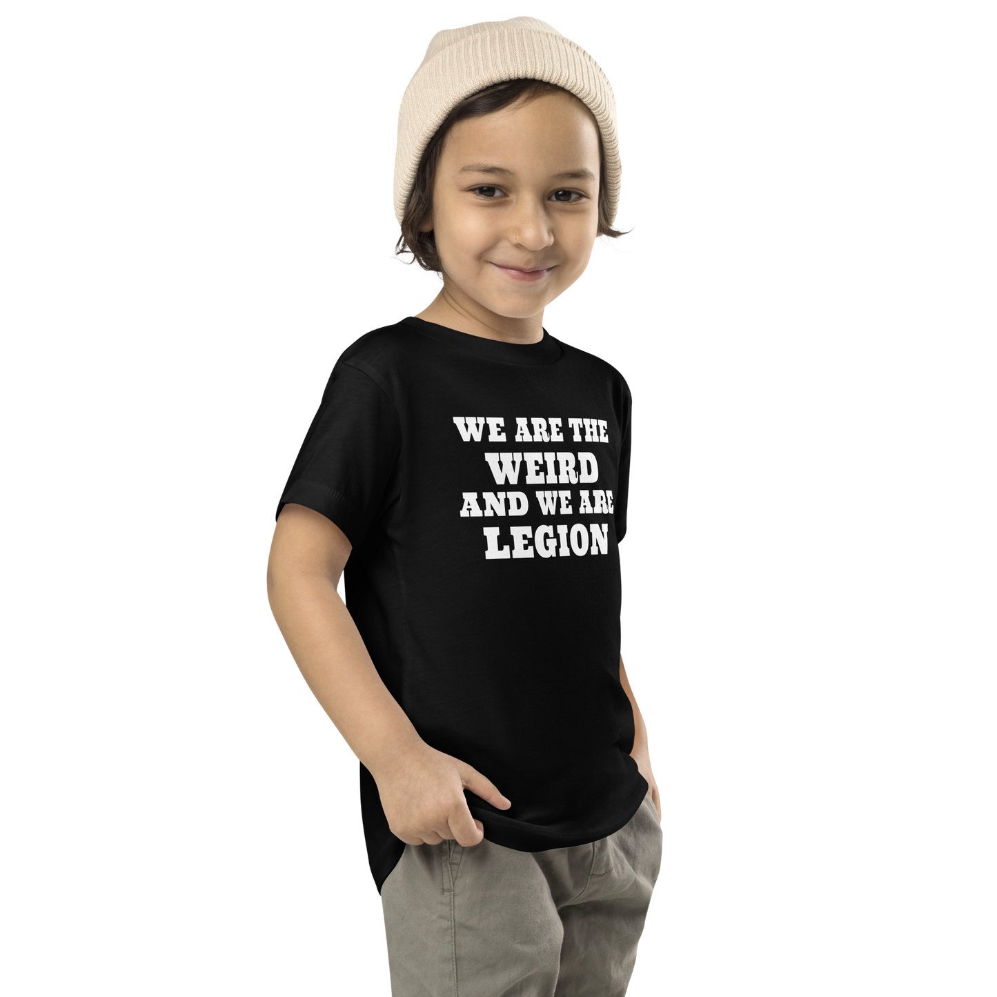 "We are the weird and we are legion" printed on a black toddler short sleeve tee worn by a male who is also wearing a knit cap