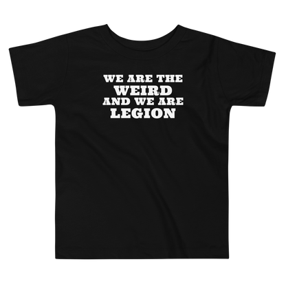 "We are the weird and we are legion" printed on a black toddler short sleeve tee laying on a flat surface