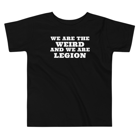 "We are the weird and we are legion" printed on a black toddler short sleeve tee laying on a flat surface