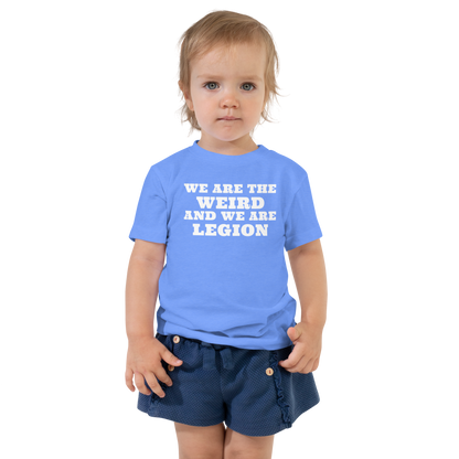 "We are the weird and we are legion" printed on a heather columbia blue toddler short sleeve tee worn by a female