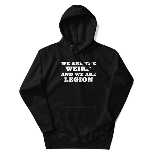 "We are the weird and we are legion" printed on a black unisex hoodie laying on a flat surface with the hood up