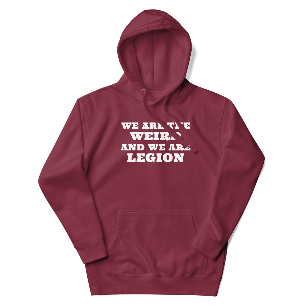 "We are the weird and we are legion" printed on a maroon unisex hoodie laying on a flat surface with the hood up