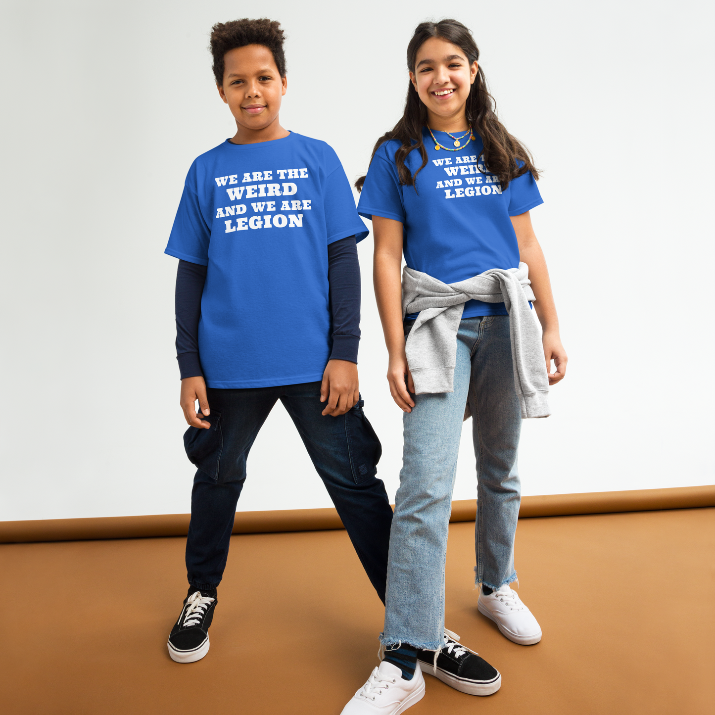 "We are the weird and we are legion" printed on a royal youth classic tee worn by a female and male