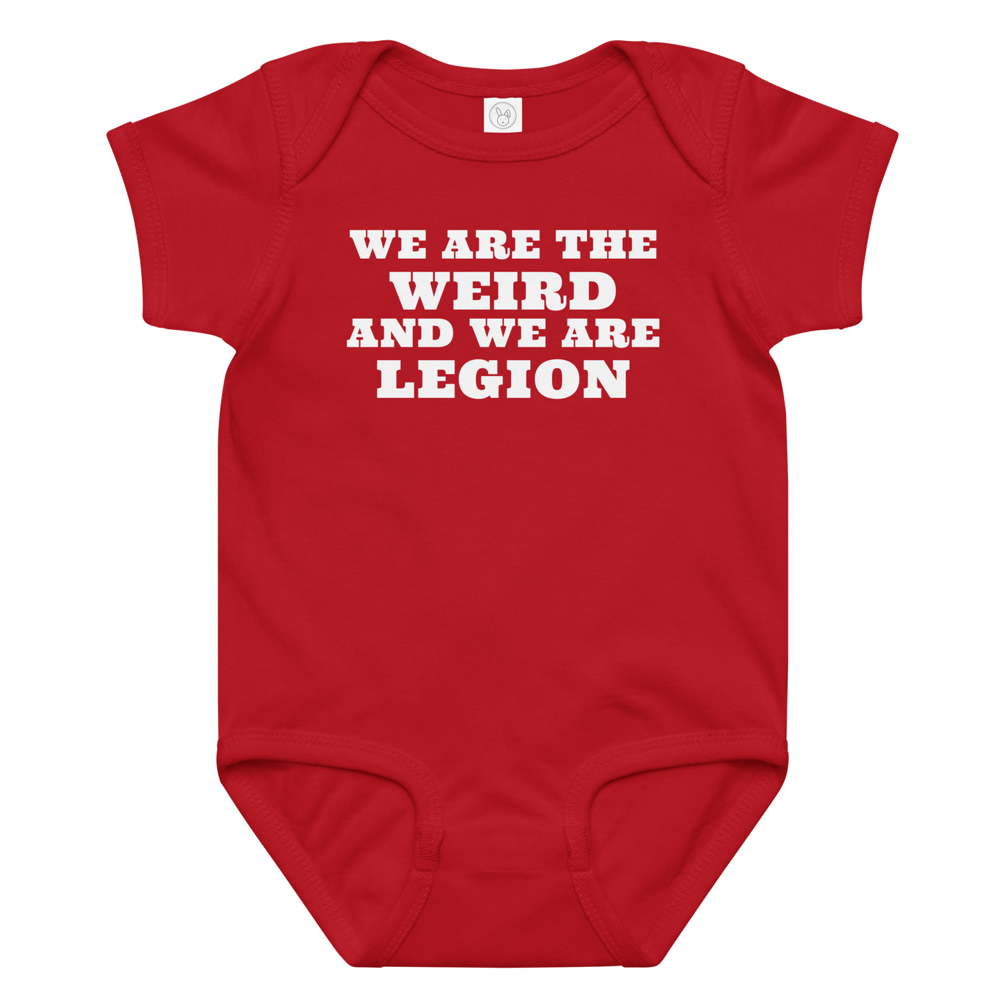 "We are the weird and we are legion" printed on a red baby jersey bodysuit laying on a flat surface amongst other clothes