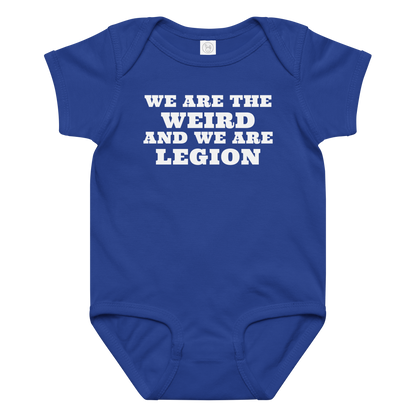 "We are the weird and we are legion" printed on a royal baby jersey bodysuit laying on a flat surface amongst other clothes
