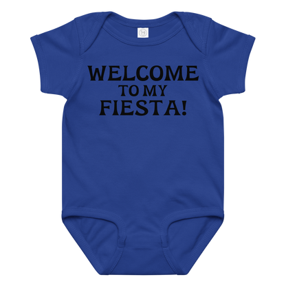 "Welcome to my fiesta!" printed on a royal baby jersey bodysuit laying on a flat surface amongst other clothes