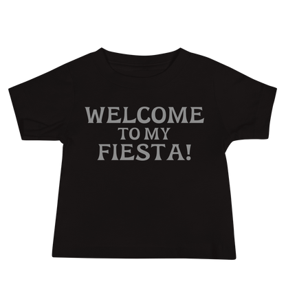 "Welcome to my fiesta!" printed on a black baby jersey short sleeve tee laying on a flat surface