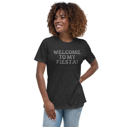 "Welcome to my fiesta!" printed on a dark grey heather women's relaxed t-shirt worn by a female