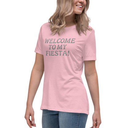 "Welcome to my fiesta!" printed on a pink women's relaxed t-shirt worn by a female