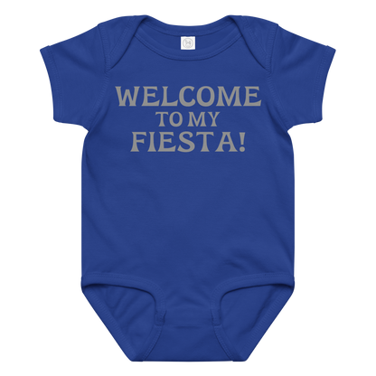 "Welcome to my fiesta!" printed on a royal baby jersey bodysuit laying on a flat surface amongst other clothes
