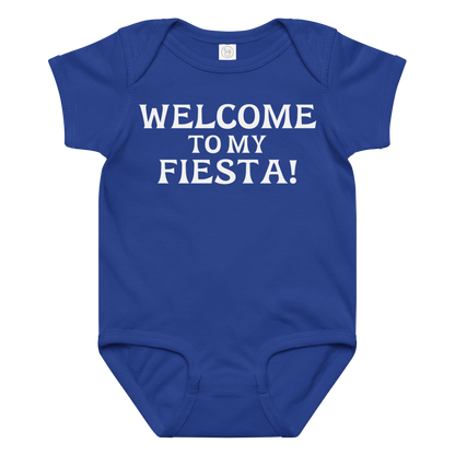 "Welcome to my fiesta!" printed on a royal baby jersey bodysuit laying on a flat surface amongst other clothes