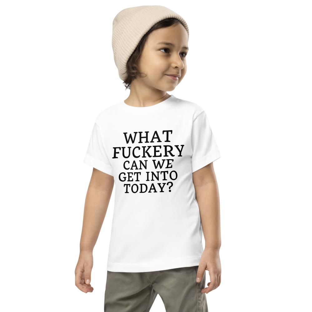 "What fuckery can we get into today?" printed on a white toddler short sleeve tee worn by a male wearing a cap