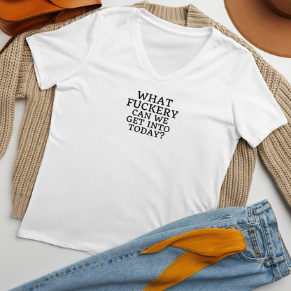 "What fuckery can we get into today?" printed on a solid white blend women's relaxed v-neck t-shirt laying on a flat surface amongst other clothes