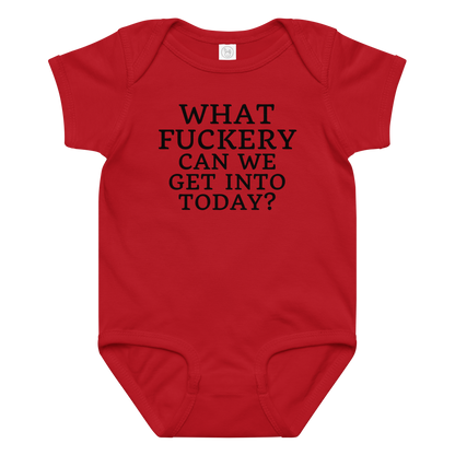 "What fuckery can we get into today?" printed on a red baby jersey bodysuit laying on a flat surface amongst other clothes