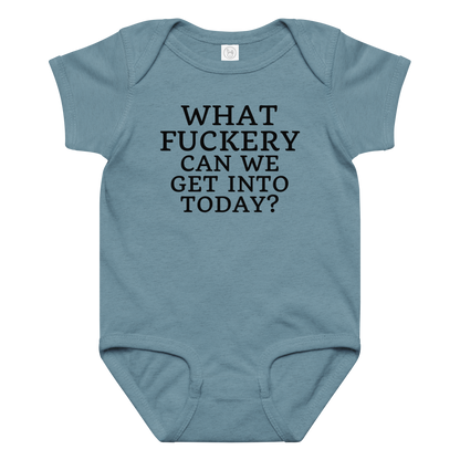 "What fuckery can we get into today?" printed on a vintage indigo baby jersey bodysuit laying on a flat surface amongst other clothes