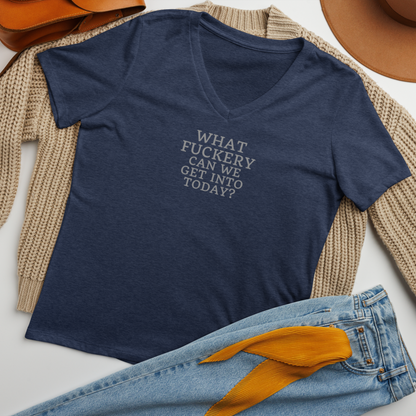 "What fuckery can we get into today?" printed on a heather navy women's relaxed v-neck t-shirt laying on a flat surface amongst other clothes