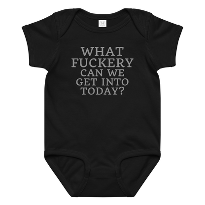 "What fuckery can we get into today?" printed on a black baby jersey bodysuit laying on a flat surface amongst other clothes