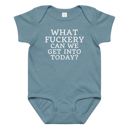 "What fuckery can we get into today?" printed on a vintage indigo baby jersey bodysuit laying on a flat surface amongst other clothes
