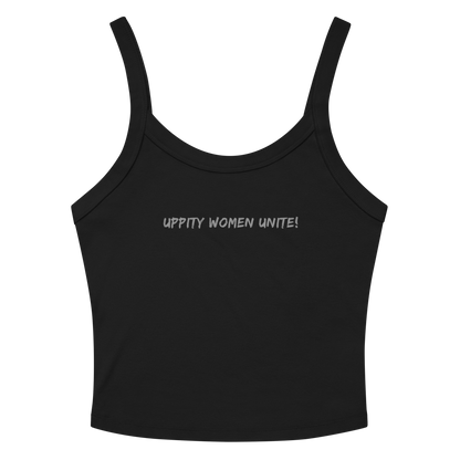 "Uppity Women Unite" printed on a solid black blend women's micro-rib tanktop laying on a flat surface amongst sunglasses and shorts