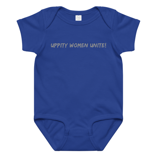 "Uppity Women Unite" printed on a royal baby jersey bodysuit laying on a flat surface amongst other clothes