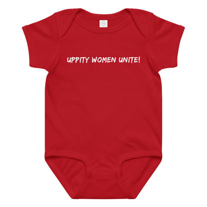 "Uppity Women Unite" printed on a red baby jersey bodysuit laying on a flat surface amongst other clothes