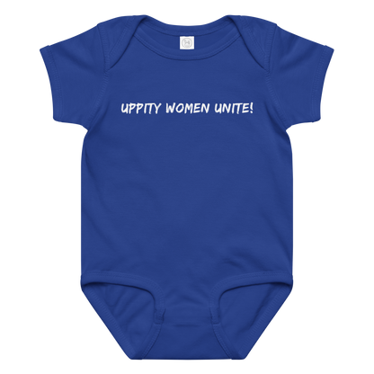 "Uppity Women Unite" printed on a royal baby jersey bodysuit laying on a flat surface amongst other clothes