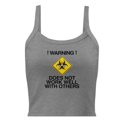 "!Warning! Does Not Work Well With Others" printed on a athletic heather women's micro-rib tanktop laying on a flat surface