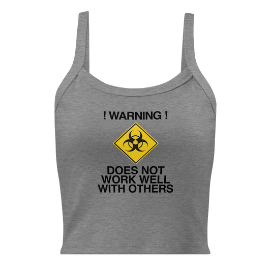 "!Warning! Does Not Work Well With Others" printed on a athletic heather women's micro-rib tanktop laying on a flat surface