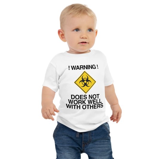 "!Warning! Does Not Work Well With Others" printed on a white baby jersey short sleeve tee worn by a male