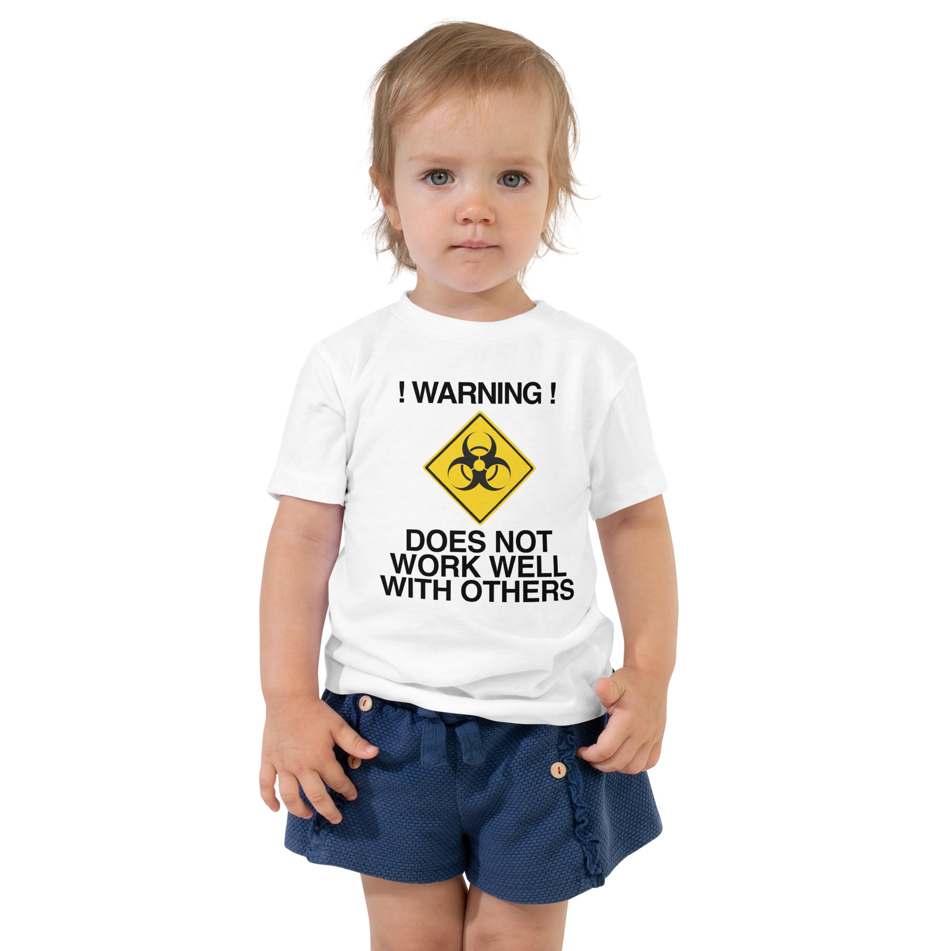 "!Warning! Does Not Work Well With Others" printed on a white toddler short sleeve tee worn by a female