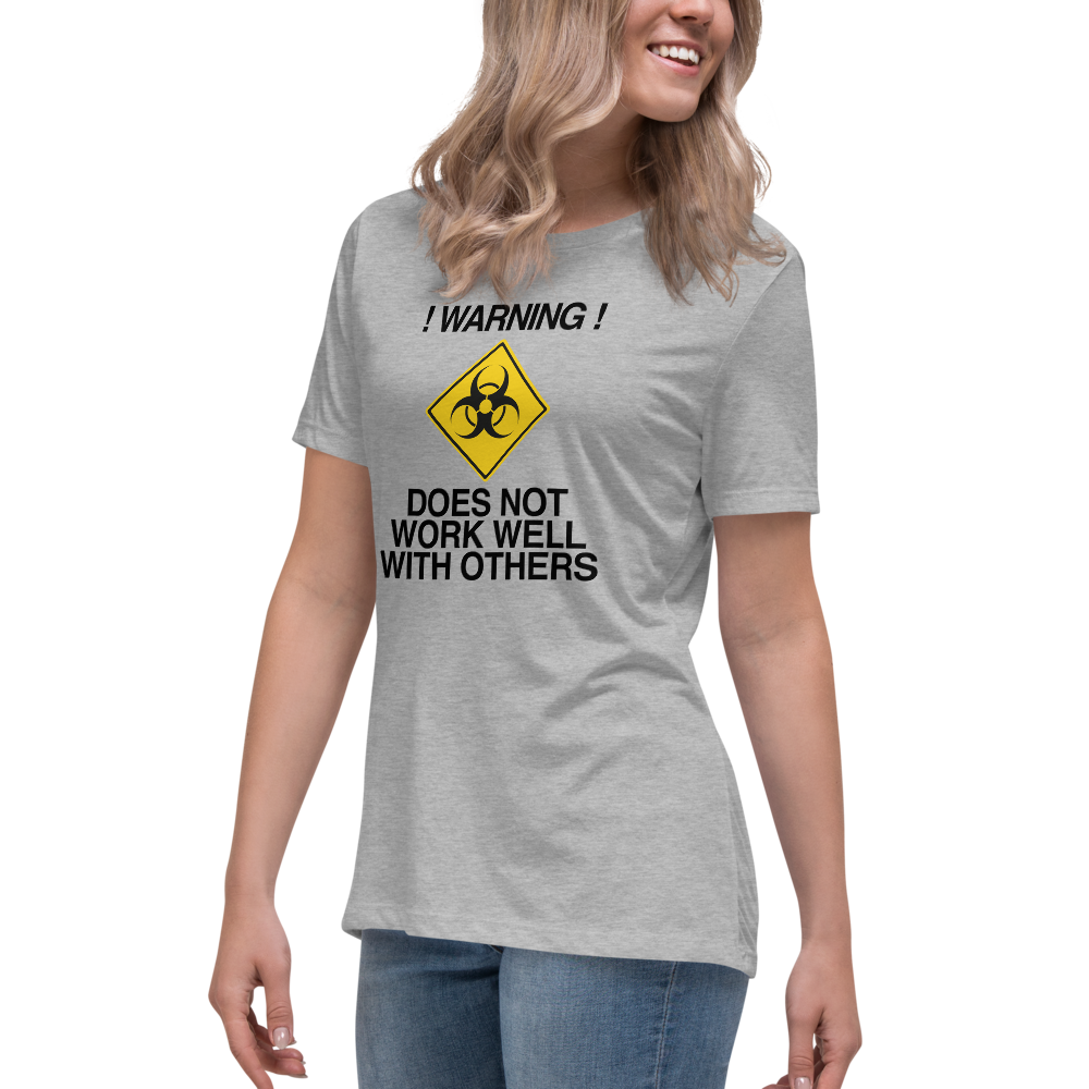 "!Warning! Does Not Work Well With Others" printed on a athletic heather women's relaxed t-shirt worn by a female