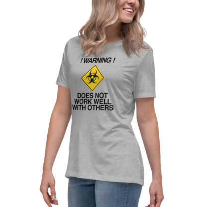 "!Warning! Does Not Work Well With Others" printed on a athletic heather women's relaxed t-shirt worn by a female