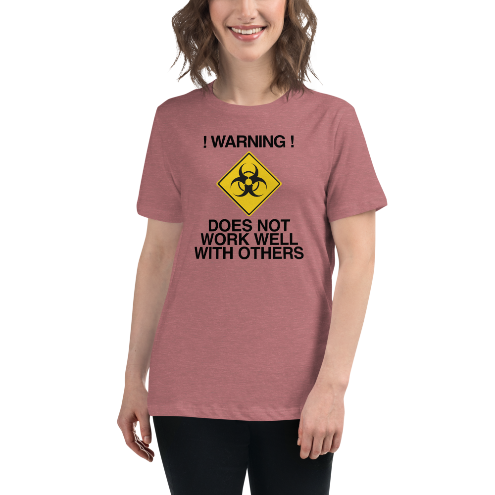 "!Warning! Does Not Work Well With Others" printed on a heather mauve women's relaxed t-shirt worn by a female
