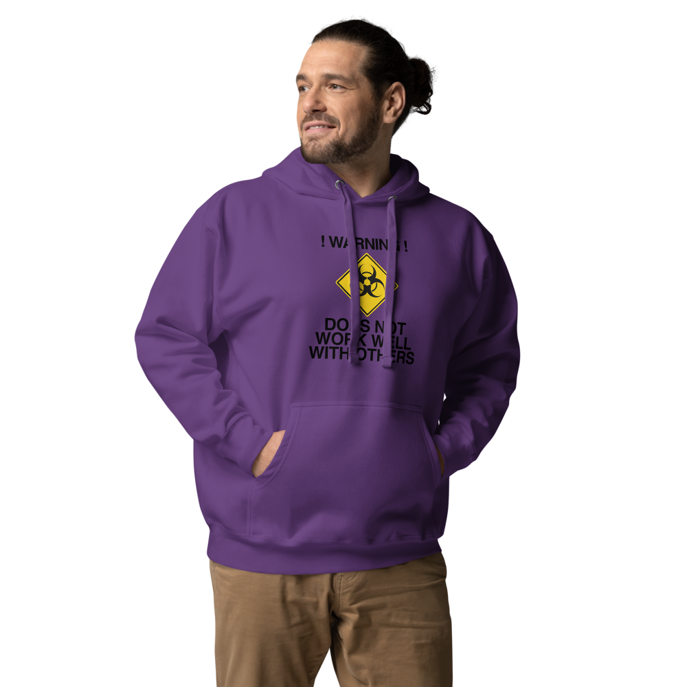 "!Warning! Does Not Work Well With Others" printed on a purple unisex hoodie worn by a male
