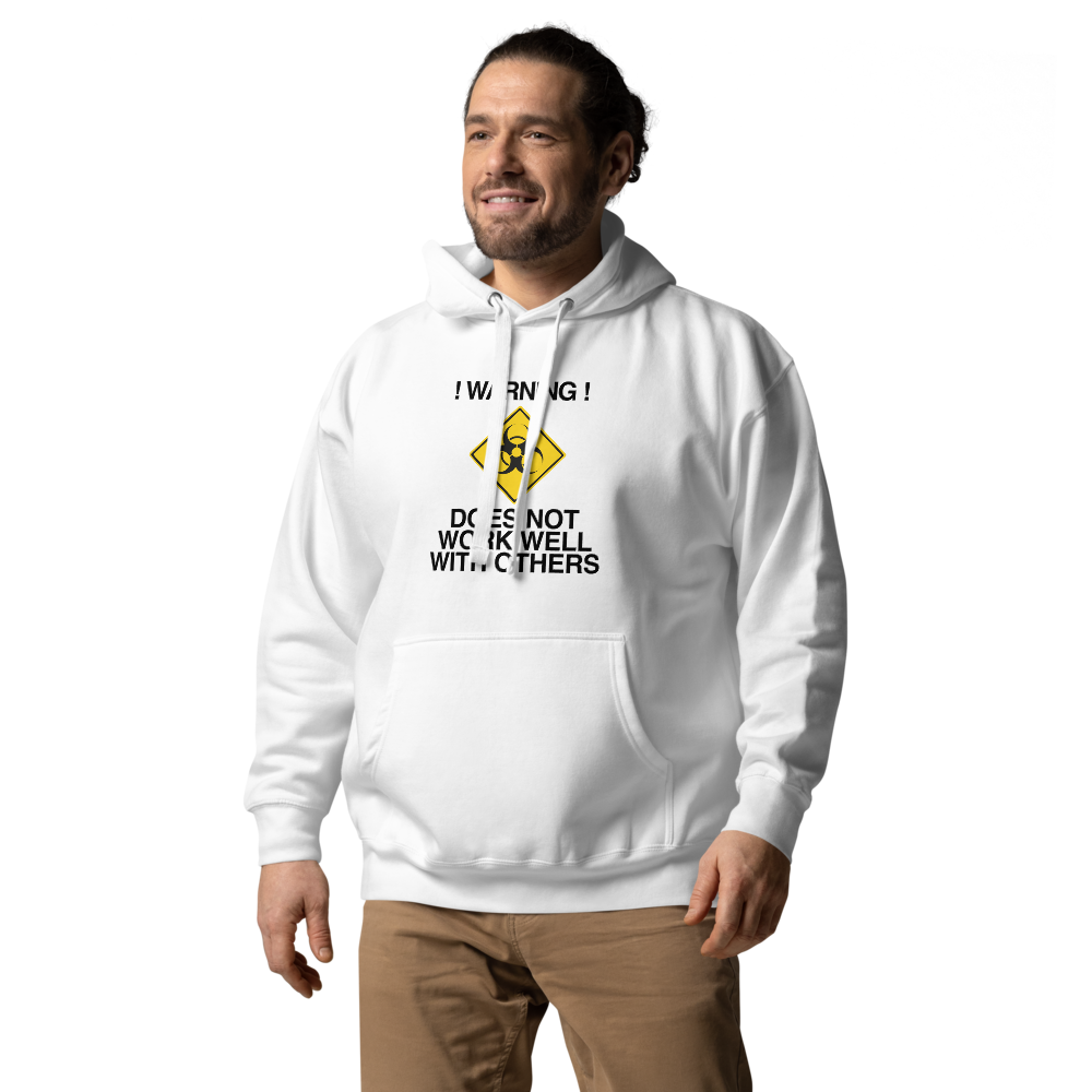 "!Warning! Does Not Work Well With Others" printed on a white unisex hoodie worn by a male