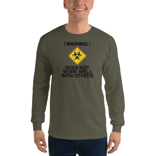 "!Warning! Does Not Work Well With Others" printed on a military green men's long sleeve shirt worn by a male