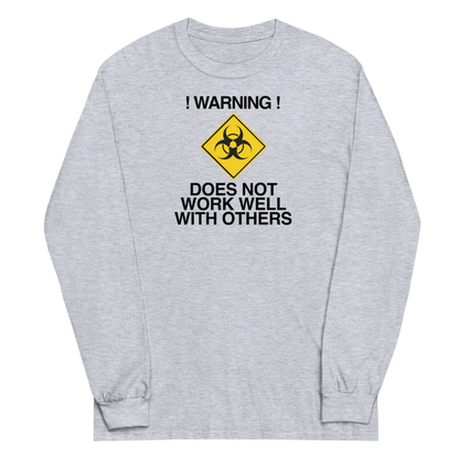 "!Warning! Does Not Work Well With Others" printed on a sport grey men's long sleeve shirt laying on a flat surface