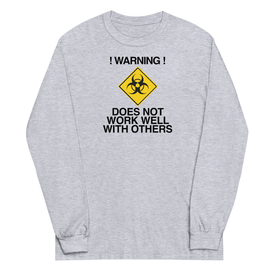 "!Warning! Does Not Work Well With Others" printed on a sport grey men's long sleeve shirt laying on a flat surface
