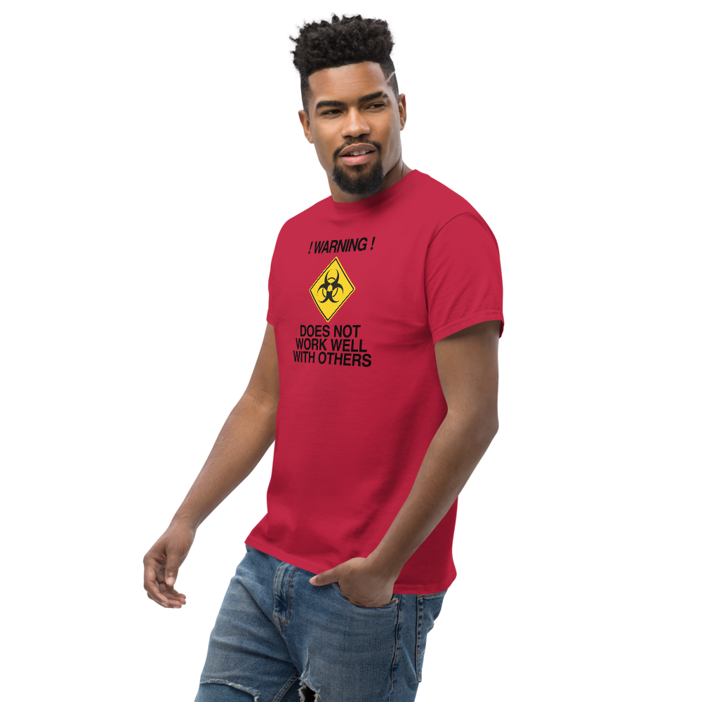 "!Warning! Does Not Work Well With Others" printed on a cardinal unisex classic tee worn by a male