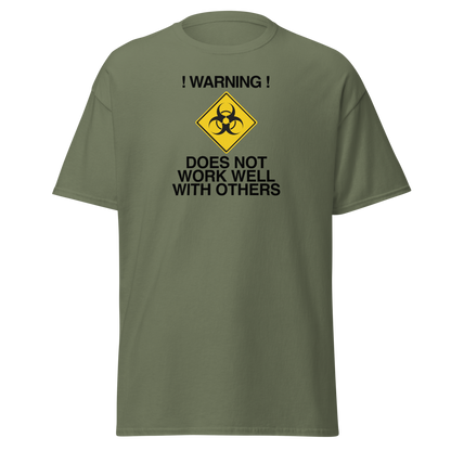 "!Warning! Does Not Work Well With Others" printed on a military green on an invisible body