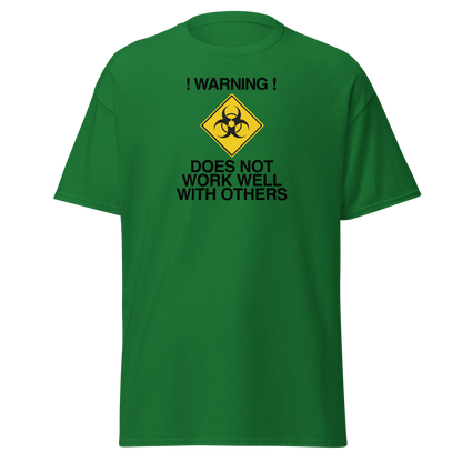 "!Warning! Does Not Work Well With Others" printed on a turf green on an invisible body