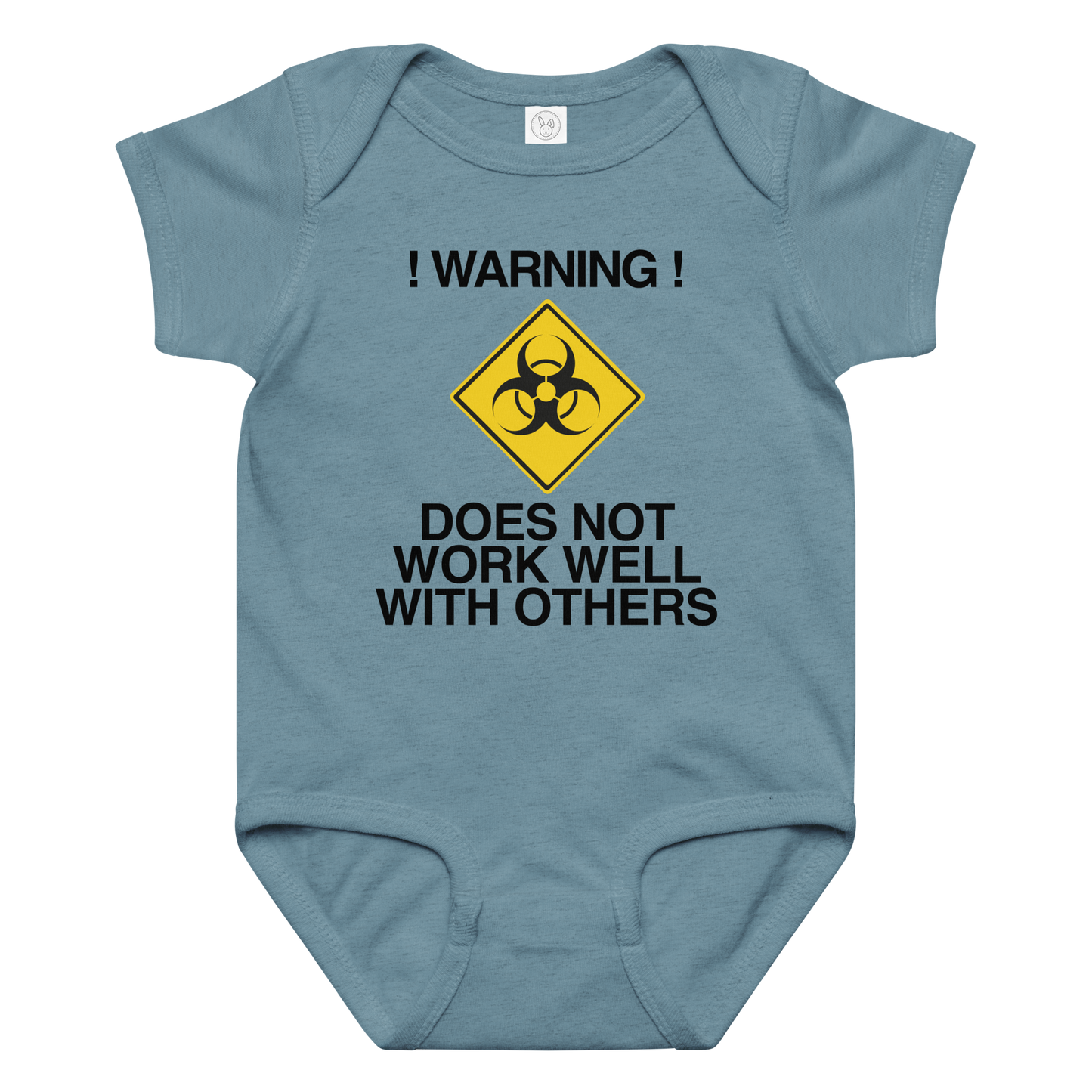 "!Warning! Does Not Work Well With Others" printed on a vintage indigo baby jersey bodysuit laying on a flat surface amongst other clothes