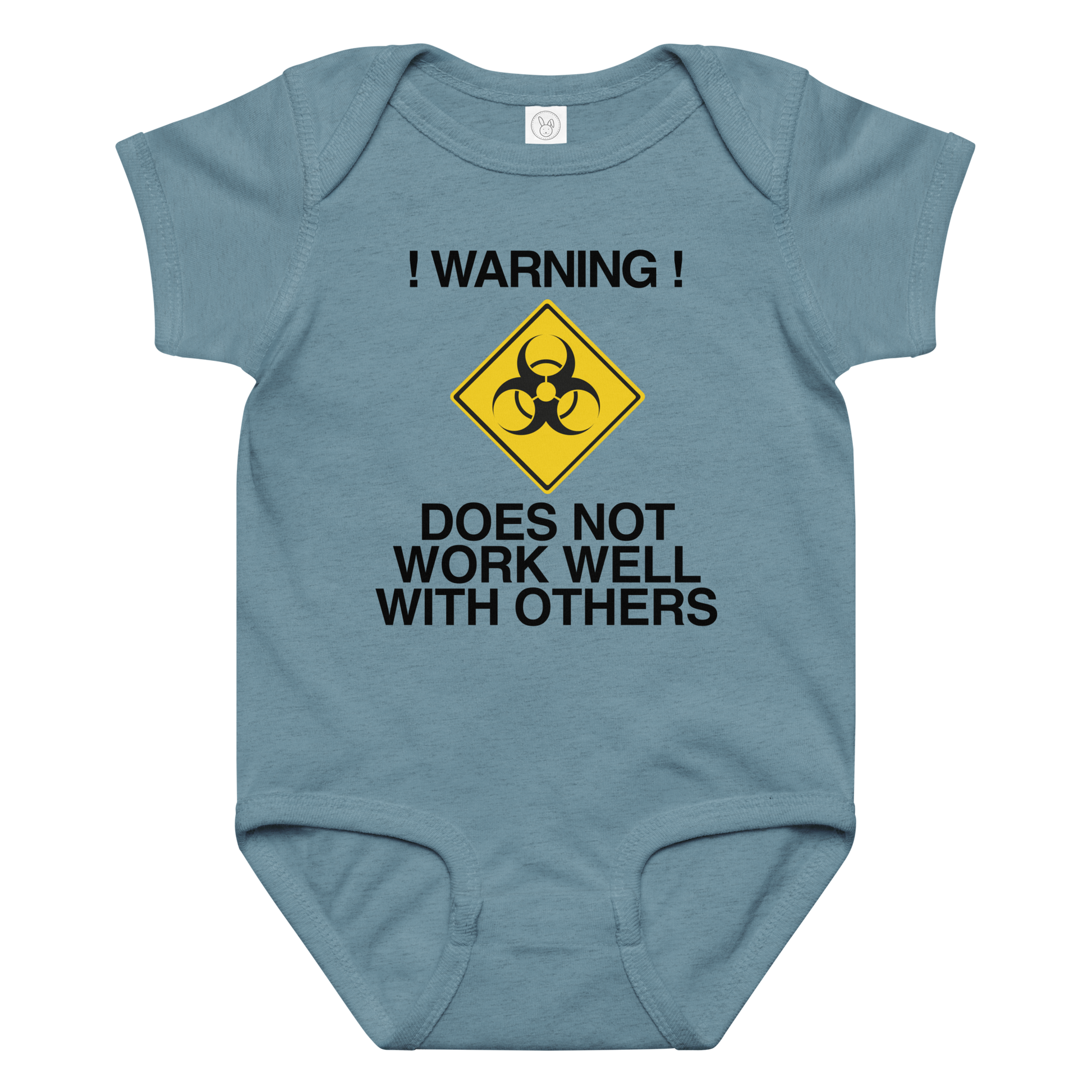 "!Warning! Does Not Work Well With Others" printed on a vintage indigo baby jersey bodysuit laying on a flat surface amongst other clothes