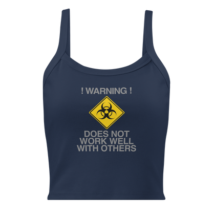 "!Warning! Does Not Work Well With Others" printed on a solid navy blend women's micro-rib tanktop laying on a flat surface